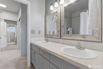 View from the primary bathroom into the primary bedroom hall and closet area.