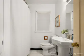 The bathroom offers a tub/shower and tile flooring.