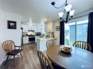 231 Maple Ave NW, Napavine WA dining room with a view into kitchen, slider to patio and the shop beyond.