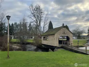 Enchanting covered bridge over Bear Creek is just one lovely feature on the grounds of Friendly Village