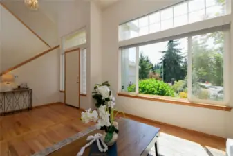 Rich red oak hardwood floors greet you with timeless elegance and warmth. Tall ceilings and an abundance of windows bring in lots of natural light and showcase the stunning beauty of the gorgeously curated landscaping surrounding the home.