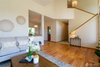 Step into the main living area where impressive ceiling heights create a breathtaking sense of space, immediately elevating the home’s overall aesthetic and welcoming atmosphere.