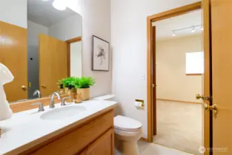 Main floor 3/4 bath with dual entry through the den/office and main living area for added convenience.