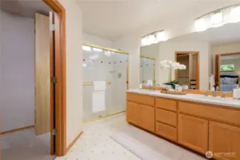 Enjoy the luxury of a walk-in closet and a second closet for added storage. The en suite bathroom is designed for relaxation, featuring dual vanities, and a walk-in shower. Additional perks include serene views of the landscaped yard, quiet separation from other bedrooms, and an overall sense of privacy—making it the perfect place to unwind at the end of the day.
