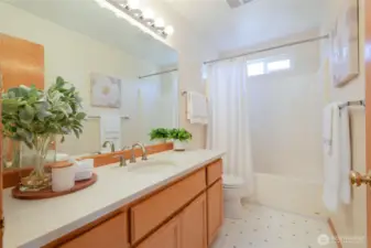 Second story Full bath with quartz countertops.