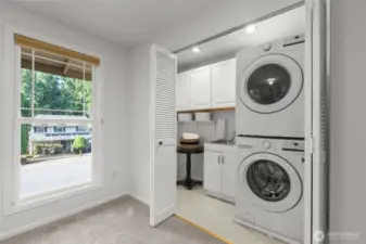 Utility closet with utility sink. Stacked appliances included.