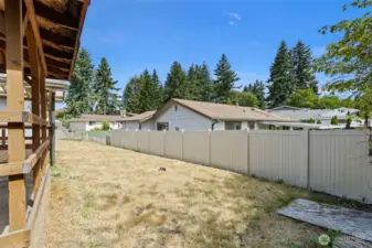 Full fenced back yard with storage shed and two covered porch areas