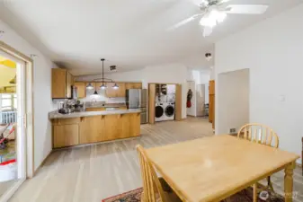 View from Dining room to Open concept Kitchen with washer/Dryer nook