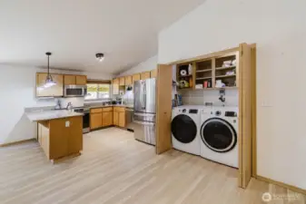 Open concept kitchen Kitchen & view of laundry nook.
