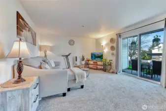 Bright and airy living room area with sliders to patio