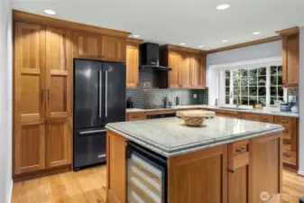 Large island for food preparation and serving.  Built in wine fridge.