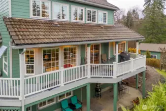 Whimsical wrap around deck looks out to the sunset.