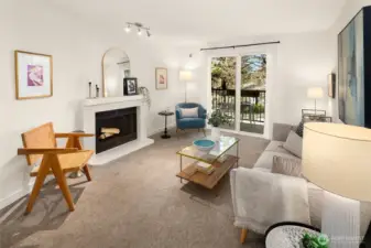 Light-filled living room anchored by a wood burning fireplace.