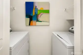 Washer and dryer off the full bathroom with nice storage above the two units.