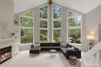 Spacious living room with stellar views of the expansive back yard and lake.