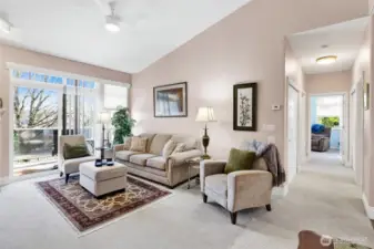 The living room features soaring vaulted ceilings and a cozy gas fireplace, creating a warm and inviting atmosphere. With its spacious layout, it’s the perfect place to relax or entertain guests.