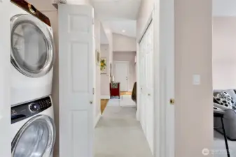 Conveniently located between the bedrooms, the closet houses a stackable washer and dryer. Its generous depth also provides valuable additional storage space.