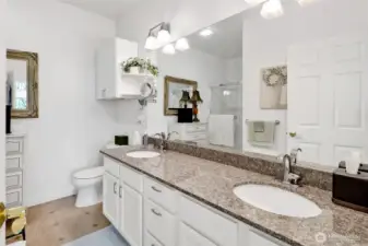 The spacious attached en-suite bath offers a double sink vanity, providing both comfort and convenience with plenty of room to get ready with ease.