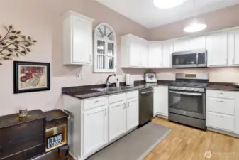 The kitchen features granite countertops, stainless steel appliances, and warm radiant heated floors—blending style, functionality, and everyday comfort.