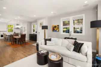 Step inside to a sun-drenched living room featuring rich hardwood floors and a warm, gas fireplace — the perfect space to relax or entertain.