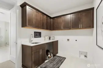 Laundry room with convenient access off primary closet and hall way