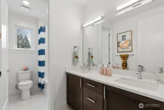 Main bath with double sinks and separate tub/shower for easy sharing