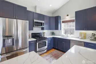 Granite countertops and stainless steel appliances.