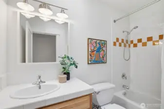 Full bath off hallway on main floor. Skylight brings in tons of light.