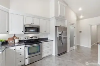 Glass door to pantry beside fridge