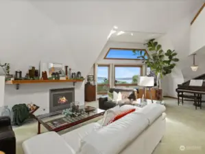 Living Room has a cozy propane fireplace & walls of windows to take in the view.