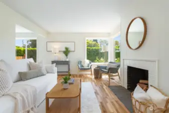 Refinished hardwoods, fresh paint and wood burning fireplace compliment the living room.