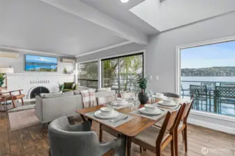 The dining room features many unique and dynamic features, from its exposed beam ceilings, to the beautiful brick surround fireplace, its warm wood floors, and its near floor to ceiling view windows. This room is truly stunning!