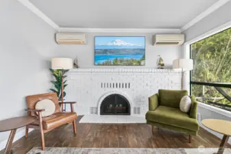 The living room features the beautiful brick surround fireplace, one of the home's most unique architectural details.
