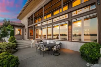 Just off the kitchen, the patio offers a front-row seat to the southern shoreline, where elegant granite details meet nature’s tranquility.