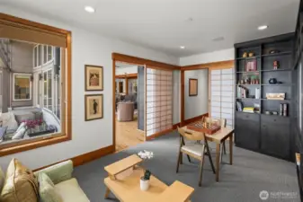 Just off the great room, Shoji screens define a flexible space—ideal as an office, TV room, or quiet retreat. Thoughtful design meets tranquil function.