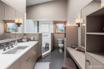 The primary bath is compact, functional, and in harmony with the home’s clean, modern lines with a walk-in closet and extra storage with style.
