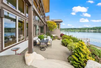 This inviting patio overlooks the bay, with steps leading through mature gardens to the waterfront—peaceful, private, and picture-perfect.
