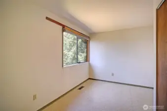 Spacious primary bedroom that looks over the beautifully landscaped yard and lake!