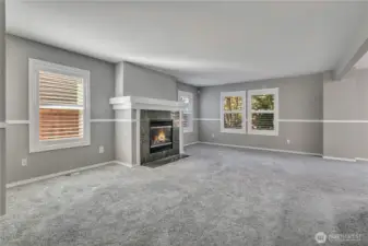 Fireplace with mantle anchors the living room with warmth and style.