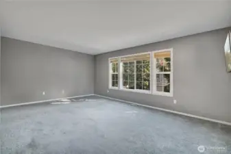 Spacious primary bedroom filled with natural light.
