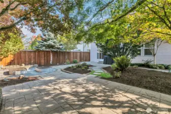 Beautiful mix of sun and shade across the yard with a separate stamped concrete pad away from the home for entertaining.