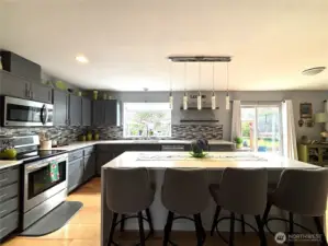 beautifully updated kitchen, stainless appliances, waterfall island, hardwood flooring...