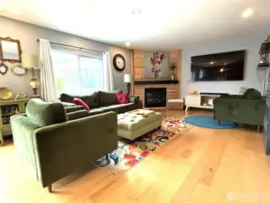 family room with flowing hardwood floors & gas fireplace