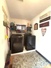 laundry room side with place for washer and dryer