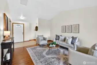 Living room w/ front door and hallway entrance to full guest bath and 3 bedrooms.