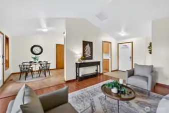 Central living area with dining nook. Vaulted ceilings throughout.