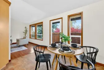 Enjoy the gorgeous trees and northerly views from the living room, and dining area. Door opens to north facing deck, which wraps around house to driveway.