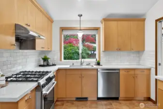 New stainless steel appliances, quartz countertops and tile backsplash.