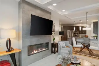 Open great-room living with a modern, sleek electric fireplace for cozy evenings, and seamless flow into the designer kitchen.