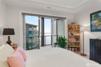 Serene primary suite with private balcony access overlooking the Sound